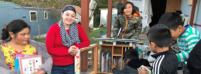 Group of kids around Little Free Library